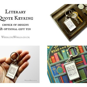 May include: Silver keychain with a rectangular tag featuring a literary quote: "If you want to change the world, pick up your pen and write." by Martin Luther King Jr.