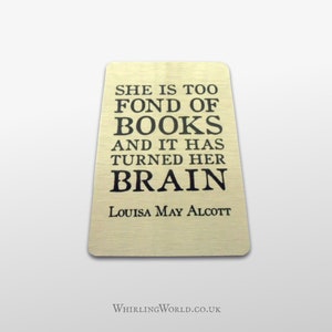 May include: A gold metal sign with a black quote that reads "She is too fond of books and it has turned her brain." The quote is attributed to Louisa May Alcott.