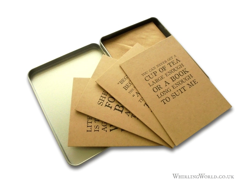 May include: A set of four brown kraft paper cards with black text quotes about tea and books. The cards are in a silver tin box with a brown paper liner.