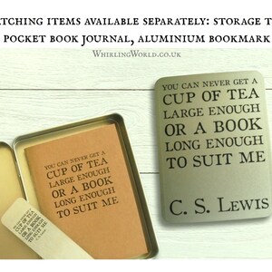 May include: A brown pocket journal with a quote from C.S. Lewis: "You can never get a cup of tea large enough or a book long enough to suit me." The journal is in a metal tin with a matching aluminum bookmark.