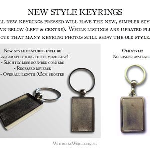 May include: Two silver keychains with rectangular metal tags. The keychain on the left has a slightly rounded corner. The keychain on the right has a sharp corner. The text on the image reads "New Style Keyrings" and "Old Style: No Longer Available".