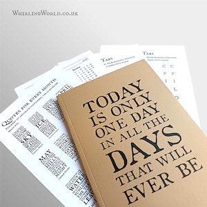 May include: A tan notebook with the black text "TODAY IS ONLY ONE DAY IN ALL THE DAYS THAT WILL EVER BE" printed on the cover, accompanied by several white sheets of paper featuring printed monthly calendars, tabs, and quotes for every month.