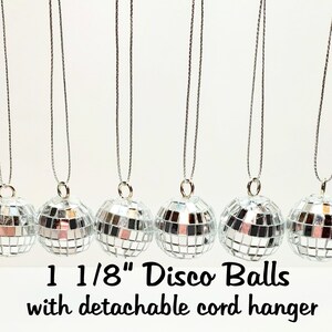 May include: Six silver 1 1/8" disco balls with detachable cord hangers.