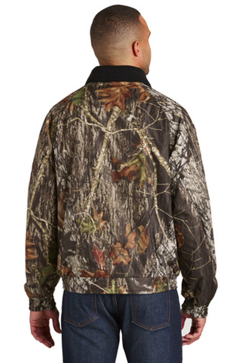 May include: A camouflage jacket with a black collar. The jacket has a zipper closure and long sleeves.