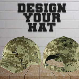 May include: A camouflage baseball cap with a green, brown, and black pattern. The cap is shown from the front and back. The text "DESIGN YOUR HAT" is displayed above the caps.