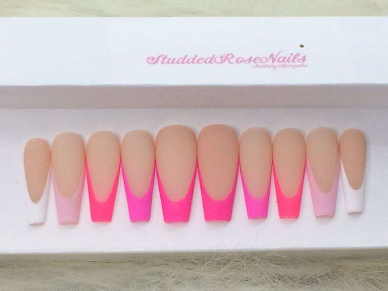 May include: Set of ten long, almond-shaped, false nails with a white tip and a gradient of pink and hot pink.
