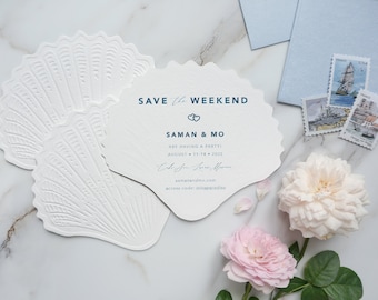May include: Save the Weekend invitation with a seashell design. The invitation is white with blue text and features the names "Saman & Mo" and the date "August 11-14, 2022".