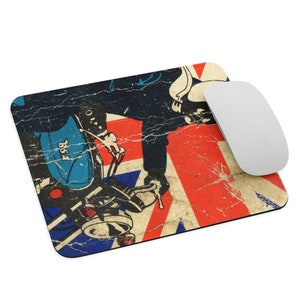 May include: A vintage-style mousepad featuring a blue and white motorcycle with a rider in front of a distressed Union Jack flag. The motorcycle has the word "BSA" on the side.