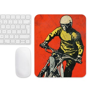 May include: A vintage-style illustration of a person riding a motorcycle on a red background. The person is wearing a yellow and black racing suit and a helmet with goggles. The motorcycle is black and white.