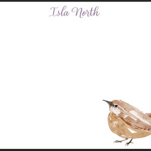 May include: White stationery with a watercolor illustration of a small brown bird. The text "Isla North" is written in a cursive font at the top of the page. The bird is detailed with brown and tan feathers.
