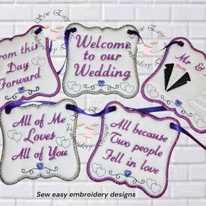 May include: Five embroidered wedding banners with purple text and accents. The banners include phrases like "Welcome to our Wedding" and "Mr & Mrs." Each banner has a scalloped edge and is attached to a purple ribbon. The words "Sew easy embroidery designs" are at the bottom.