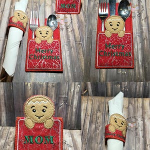 May include: Red and beige Christmas-themed embroidered napkin rings and utensil holders. The holders feature a gingerbread man design and the words "Merry Christmas" and "MOM". The napkin rings and utensil holders are on a wooden surface.