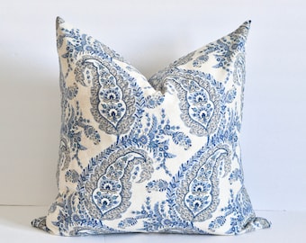 May include: A white pillow with a blue and gray paisley pattern.