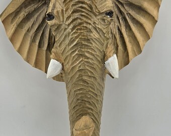 Hand Carved , Glass Eyed Elephant wall hanging. 8" tall, 6.5" wide. Light gloss on wood.  Ready to hang. Fabulous Art! Ships to USA only