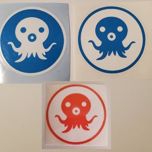 May include: Three stickers featuring a cartoon octopus with a white body and blue or red accents. The octopus has two large eyes and a small mouth. The stickers are on a white background.