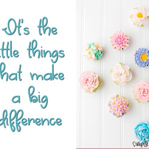 May include: A collection of cupcakes decorated with colorful buttercream frosting flowers. The cupcakes are arranged in a heart shape on a white background. The text "It's the little things that make a big difference" is written in blue on the left side of the image. The text "Simply Angela" is written in pink at the bottom right of the image.