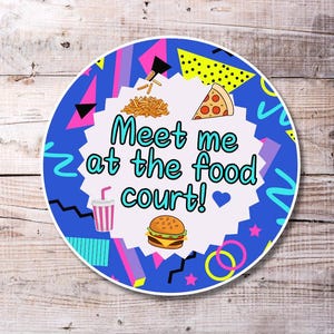 May include: A blue and pink 90s themed sticker with the text "Meet me at the food court!" and images of a burger, pizza, fries, and a soda.
