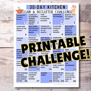 May include: A printable 30-day kitchen clean and declutter challenge checklist. The calendar features a blue and white design with daily tasks like cleaning the fridge, organizing drawers, and decluttering. The words "Printable Challenge!" are in bold.