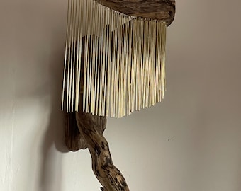 Driftwood art with brass pendants