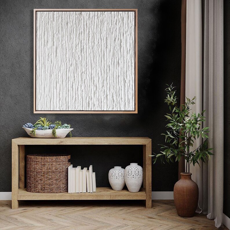 Minimalist white abstract textured painting on canvas.
The painting changes with the different light of day, always creating new lights and shadows.
The clean white is perfect for the minimalist design lover.