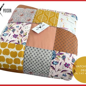 May include: A patchwork quilt with a variety of patterned squares in shades of yellow, pink, brown, and blue. The quilt features floral, leaf, and apple designs. The quilt measures approximately 57 x 75 inches.