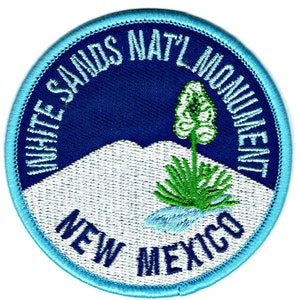May include: White Sands National Monument embroidered patch with a blue background, white mountains, a green yucca plant, and the text "White Sands Nat'l Monument New Mexico".
