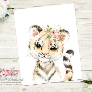 May include: A watercolor painting of a cute tiger cub with a pink flower crown. The tiger has brown and white stripes and big brown eyes. The background is white.