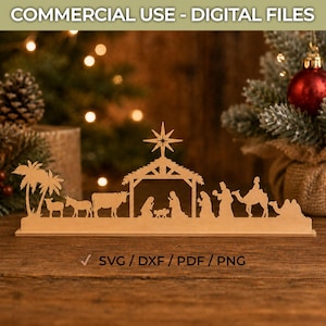 May include: A laser-cut wooden nativity scene silhouette featuring a stable with a star, palm trees, animals, and figures. The text "COMMERCIAL USE - DIGITAL FILES" appears at the top, and "✓ SVG / DXF / PDF / PNG" is printed at the bottom.
