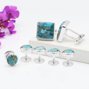 May include: A set of three ceramic mugs with a speckled, matte finish. The mugs are in shades of cream, light gray, and dark gray. Each mug has a simple, minimalist design, perfect for coffee or tea.