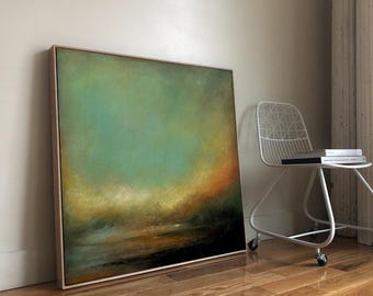 May include: Abstract landscape painting in a wooden frame. The artwork features a blend of teal, yellow, orange, and black hues, creating a moody and atmospheric scene. The painting leans against a wall on a hardwood floor.