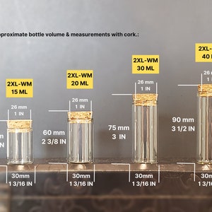 May include: Four clear glass bottles with cork stoppers and measurements in inches and millimeters. The bottles are labeled with the text "2XL-WM" and the volume in milliliters: 15 ML, 20 ML, 30 ML, and 40 ML.