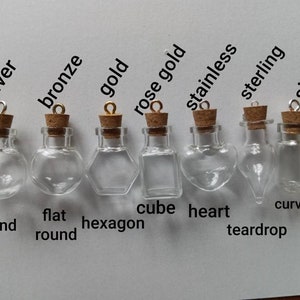 May include: Eight glass bottles with cork stoppers and metal caps in various shapes, including round, flat round, hexagon, cube, heart, teardrop, and curve base. The bottles are labeled with different metal finishes: silver, bronze, gold, rose gold, stainless, sterling, and silver.