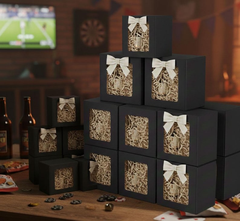 May include: A stack of black gift boxes with white bows, each featuring a window revealing a glass container filled with shredded paper. The boxes are arranged on a wooden table, suggesting a gift or party theme.