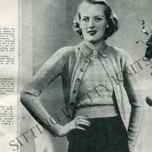 May include: A close-up of a woman wearing a light blue knitted cardigan and matching sweater. The cardigan has a button-up front and a collar. The sweater has a crew neck. The woman is standing with her hands on her hips. The image includes text that reads "Sitting Pretty Knits".