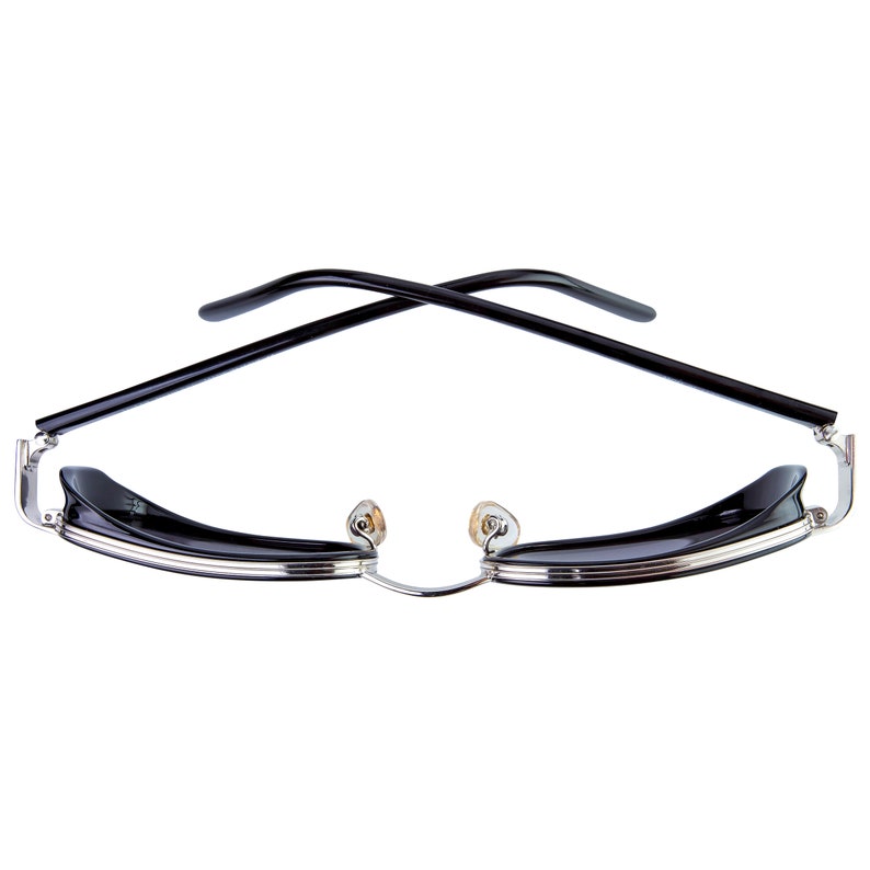 May include: Black sunglasses with a silver frame and black lenses. The arms of the sunglasses are crossed over each other.