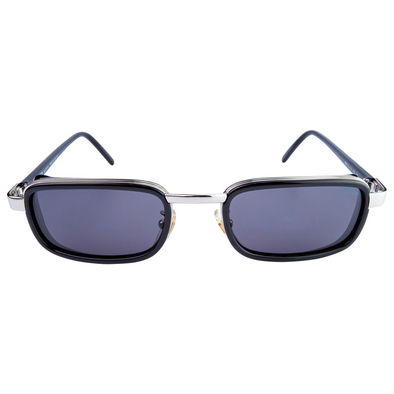 May include: Black sunglasses with a silver metal frame and dark lenses.
