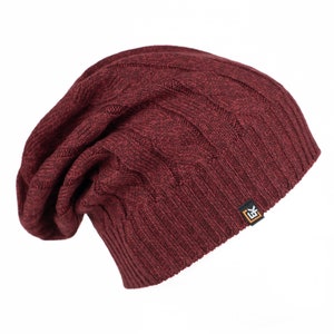 May include: A burgundy knitted beanie with a cable knit pattern and a small black and orange logo on the side.