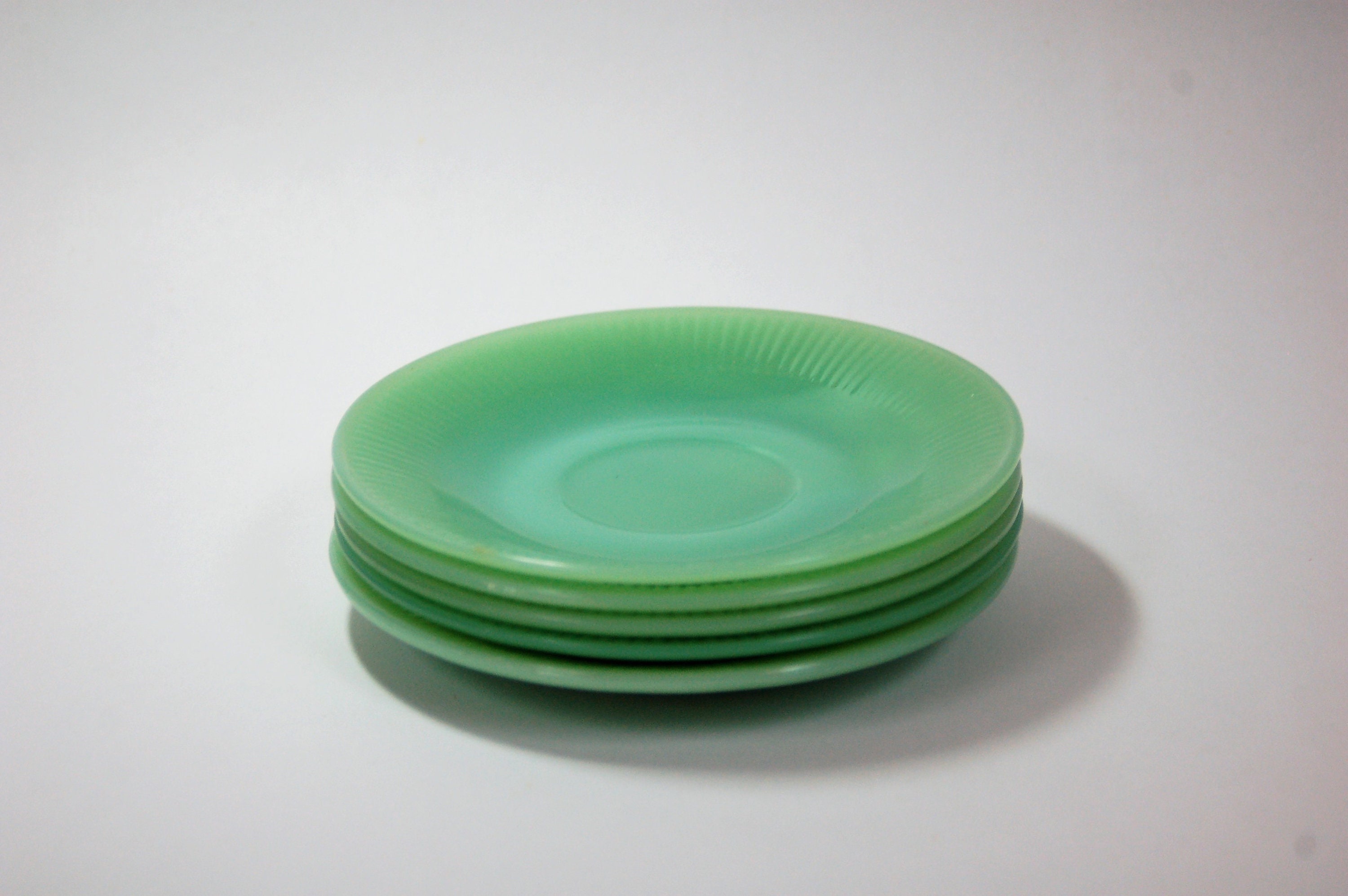 Jadeite 53/4 saucers. Set of four Fire King Oven Glass, Jane Ray pattern.