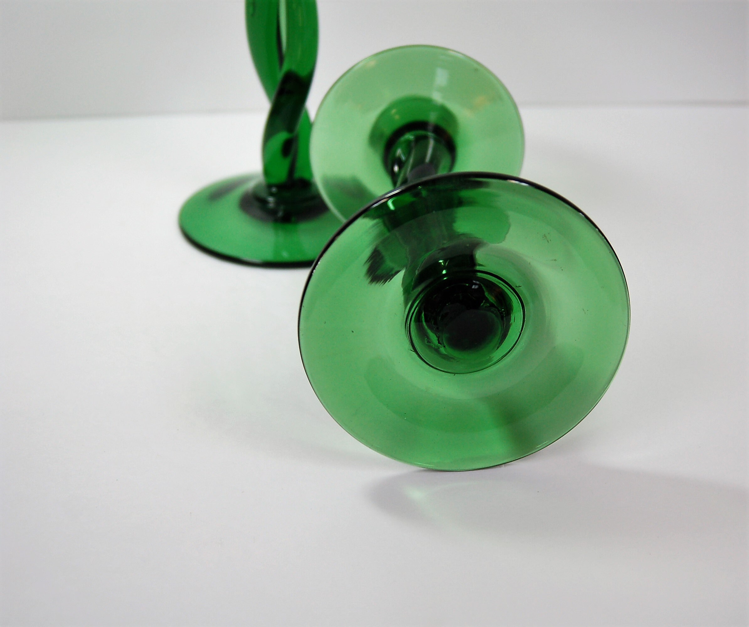 Pair of emerald green hand blown glass candle holders with twisted stem