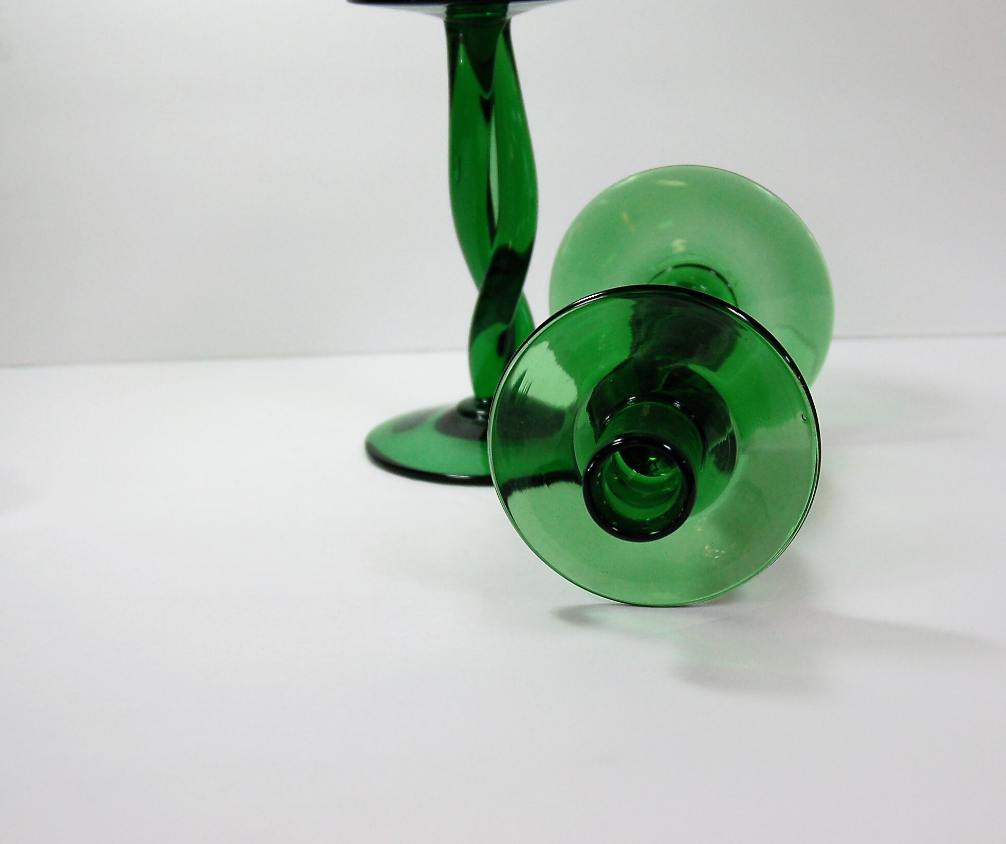 Pair of emerald green hand blown glass candle holders with twisted stem