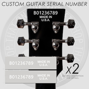 May include: Close-up of a black guitar headstock with silver tuning pegs. The text "CUSTOM GUITAR SERIAL NUMBER" is at the top. Two labels with the text "B01236789 MADE IN U.S.A." are shown, along with the text "x2 SEE ITEM DESCRIPTION FOR DETAILS."