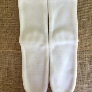 White fleece socks with green stitching on top hem. Women’s size 10.