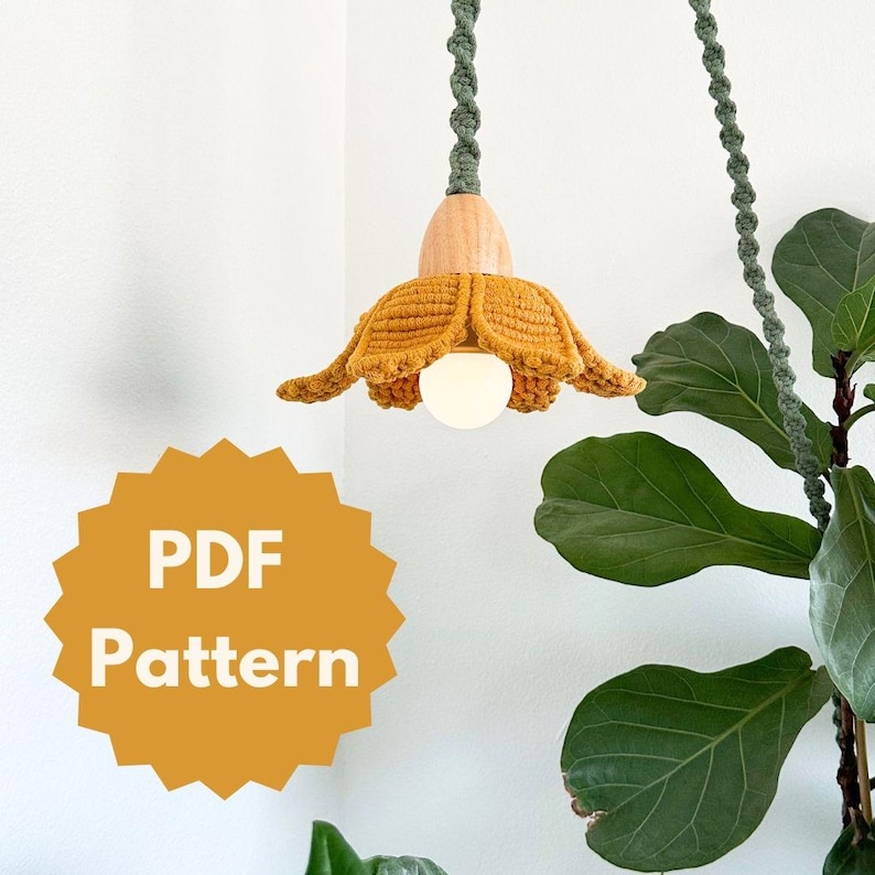 May include: A PDF pattern for a crocheted flower lampshade. The lampshade is yellow and has a wooden base. The pattern is available for download.
