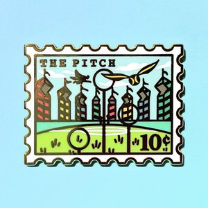 May include: A gold-colored enamel pin shaped like a postage stamp with the text "THE PITCH" and a depiction of a Quidditch match with players flying on broomsticks and a snitch.