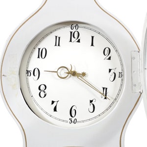 May include: White wooden clock face with black Roman numeral hour markers and black Arabic numeral minute markers. The clock hands are gold.