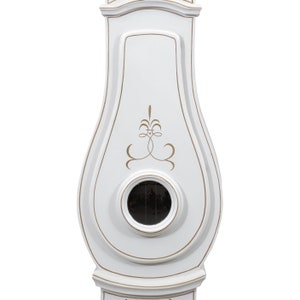 May include: White grandfather clock with a gold-painted design and a small, round, black clock face.