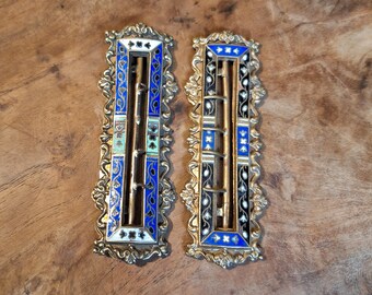 Pair of 19th century rectangular belt buckles in blue and black cloisonné enamels with flower friezes on gilded brass