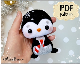 May include: A PDF pattern for sewing a cute penguin plush toy. The penguin is holding a candy cane and has a black and white body with a gray belly. The pattern is available for download.