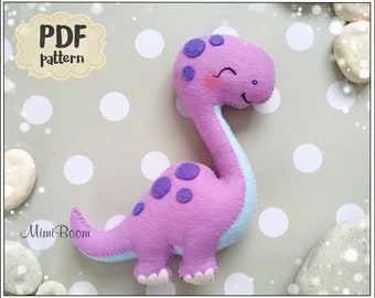 May include: PDF pattern for a purple and blue felt dinosaur toy with a smiling face. The dinosaur has white feet and purple spots.