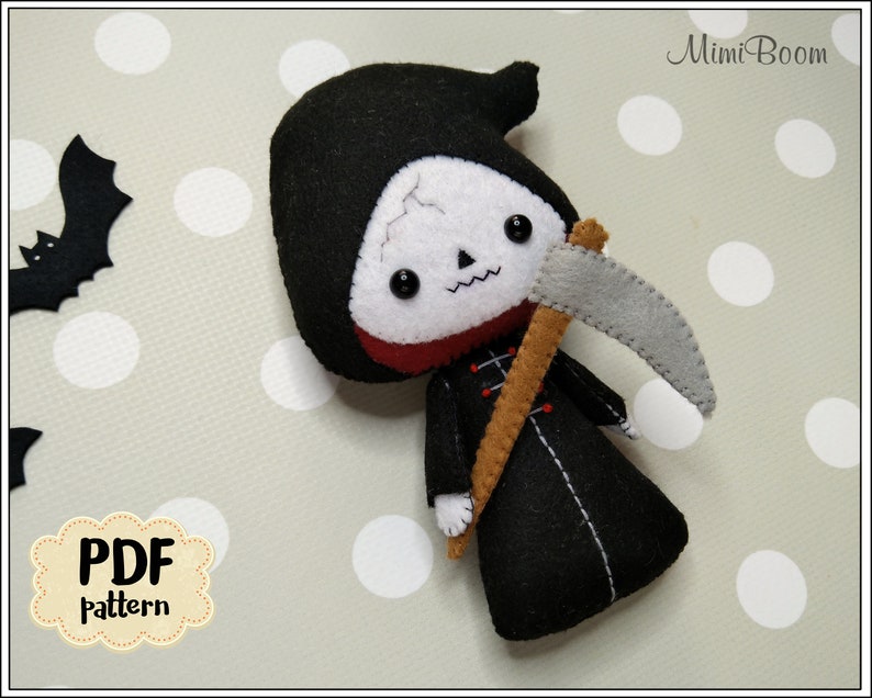 May include: A handmade felt Grim Reaper doll with a black hooded robe, holding a gray scythe. The doll has a white skull face with black eyes and a red collar. The image includes a PDF pattern label and a felt bat.